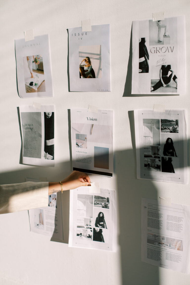Editorial mood board with fashion magazine layouts and vision board elements on white wall